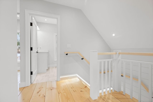 540 S Orleans Rd, Orleans, MA 02653 - corridor with an upstairs landing, wood finished floors, lofted ceiling, a sink, and recessed lighting