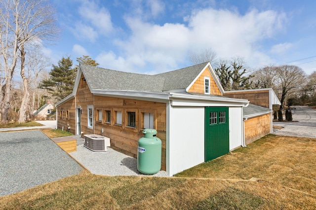 540 S Orleans Rd, Orleans, MA 02653 - view of side of home with roof with shingles, central air condition unit, and a yard