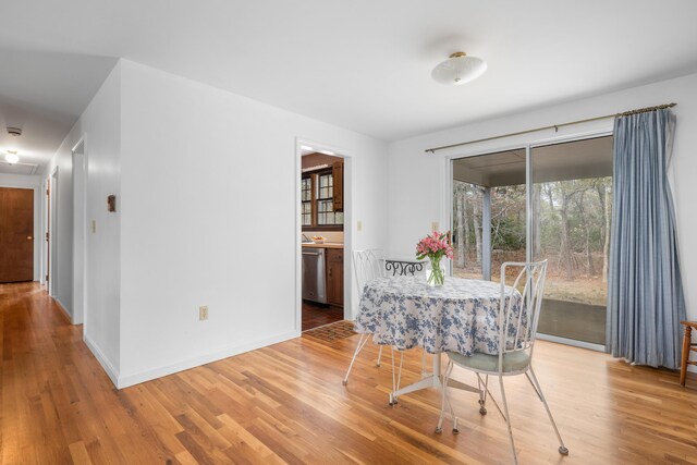dining area with wood finished floors and baseboards