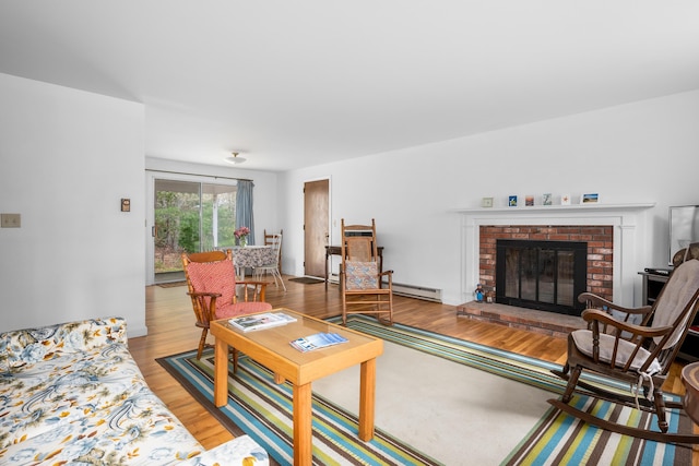 living room with a baseboard radiator, wood finished floors, and a fireplace