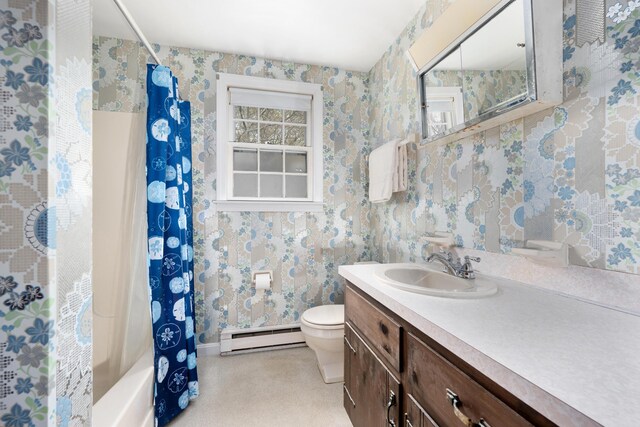 bathroom with baseboard heating, toilet, vanity, wallpapered walls, and baseboards