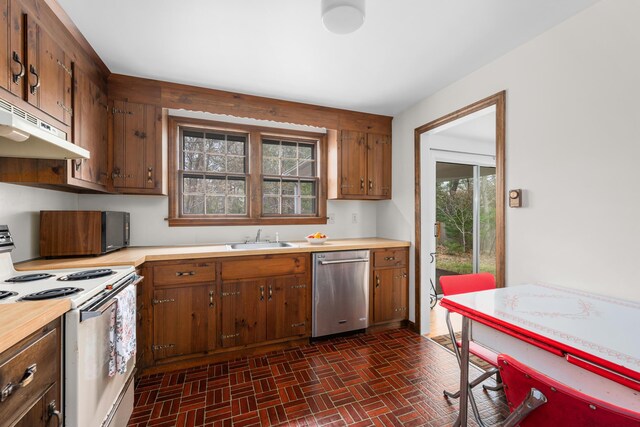 kitchen with white electric range, dishwasher, a sink, brick patterned floors, and light countertops
