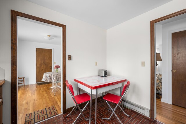dining room with baseboards and brick patterned flooring