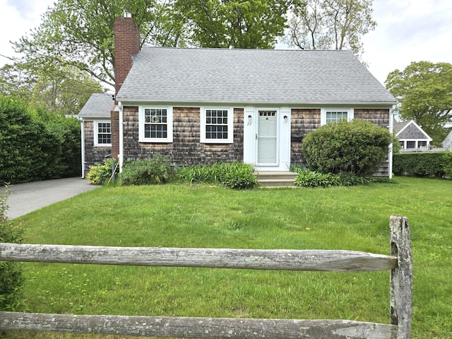 22 Cypress St, East Falmouth, MA 02536 - view of front of property featuring a chimney, a shingled roof, a front lawn, and entry steps