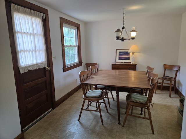 22 Cypress St, East Falmouth, MA 02536 - dining room featuring a chandelier, tile patterned floors, and baseboards