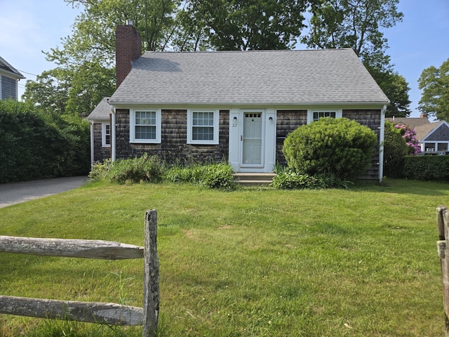 22 Cypress St, East Falmouth, MA 02536 - view of front of house with a chimney, roof with shingles, a front lawn, and entry steps