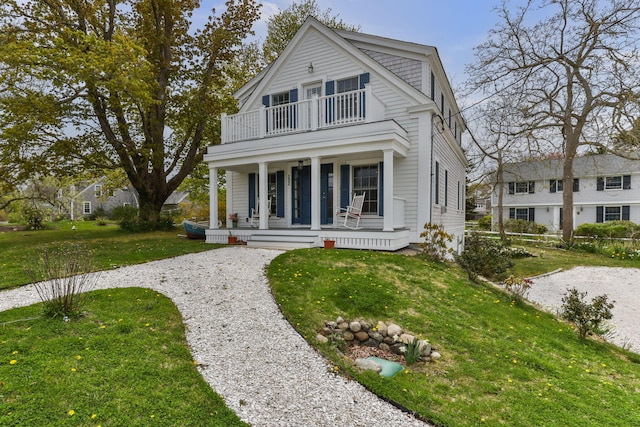 292 Stage Harbor Rd, Chatham, MA 02633 - view of front of property with covered porch, a balcony, and a front lawn