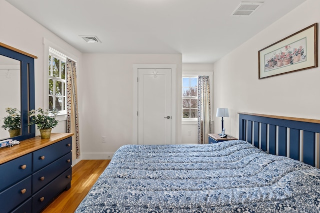 292 Stage Harbor Rd, Chatham, MA 02633 - bedroom featuring multiple windows, light wood-style floors, and baseboards