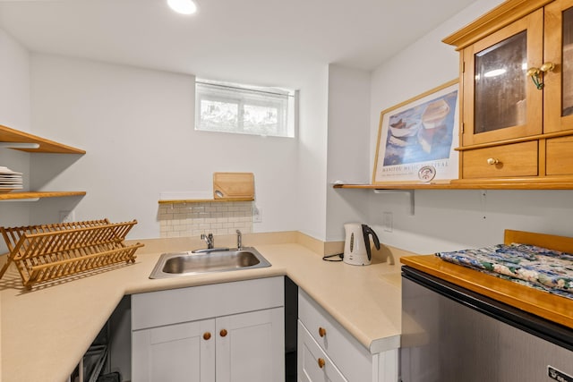 292 Stage Harbor Rd, Chatham, MA 02633 - kitchen featuring light countertops, a sink, open shelves, white cabinetry, and glass insert cabinets