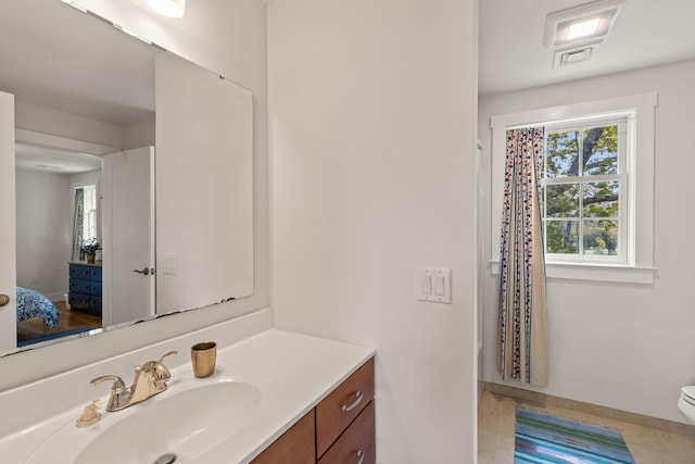 292 Stage Harbor Rd, Chatham, MA 02633 - ensuite bathroom featuring vanity, toilet, and baseboards