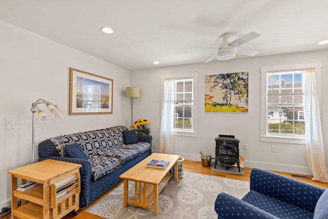 292 Stage Harbor Rd, Chatham, MA 02633 - living room featuring a wood stove, ceiling fan, wood finished floors, recessed lighting, and baseboards