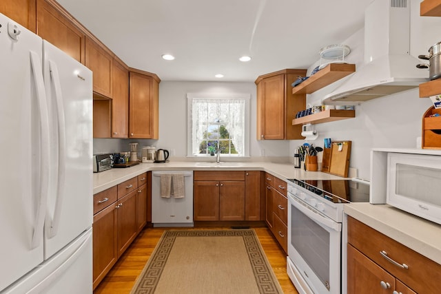 292 Stage Harbor Rd, Chatham, MA 02633 - kitchen featuring white appliances, island range hood, light wood-style floors, brown cabinets, and recessed lighting