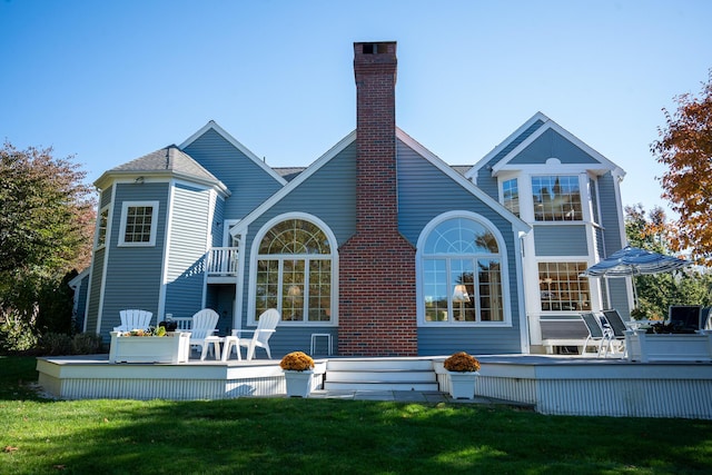 47 Stoney Pond Cir, Marstons Mills, MA 02648 - back of property with a chimney, a deck, and a yard