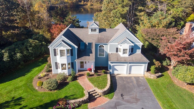 47 Stoney Pond Cir, Marstons Mills, MA 02648 - view of front of house featuring driveway, a front lawn, a water view, and a shingled roof