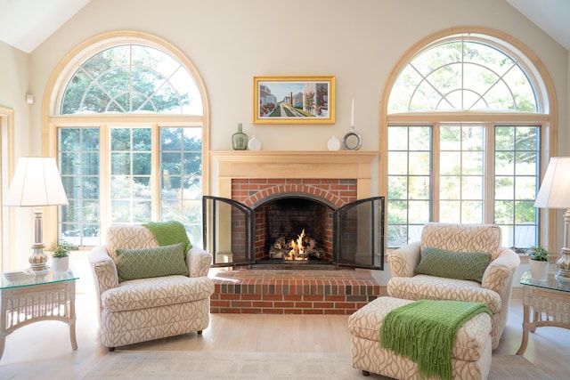 47 Stoney Pond Cir, Marstons Mills, MA 02648 - living area featuring healthy amount of natural light, a brick fireplace, wood finished floors, and high vaulted ceiling