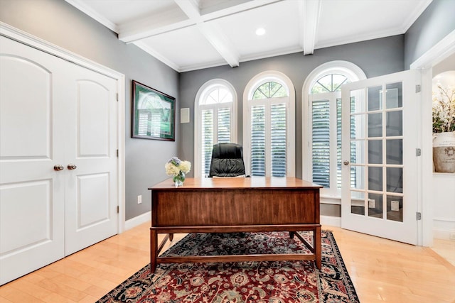 office space with light wood-type flooring, coffered ceiling, beamed ceiling, and baseboards