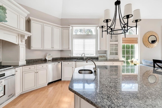 kitchen featuring a sink, stainless steel dishwasher, plenty of natural light, and wall oven