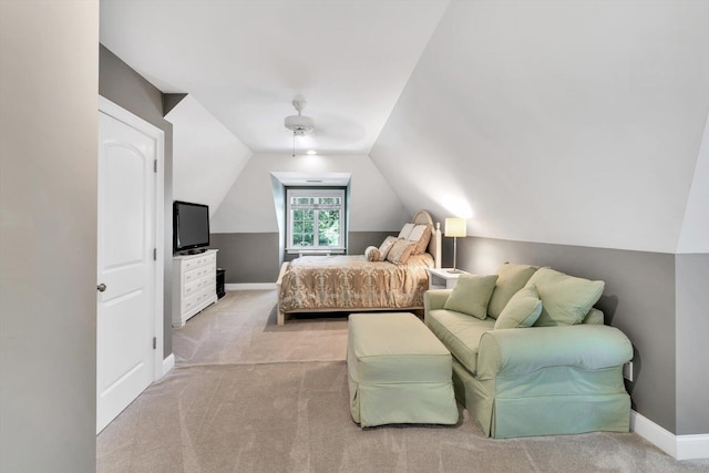 carpeted bedroom with lofted ceiling, baseboards, and a ceiling fan