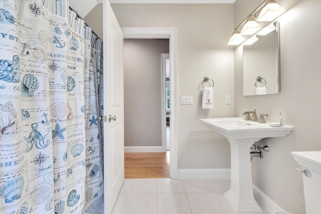 bathroom featuring tile patterned flooring, a shower with curtain, and baseboards