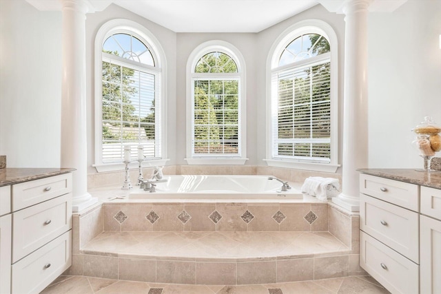 full bath featuring a wealth of natural light, ornate columns, and a bath