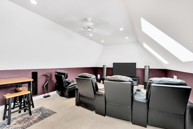 home theater room with recessed lighting, lofted ceiling with skylight, ceiling fan, and light colored carpet