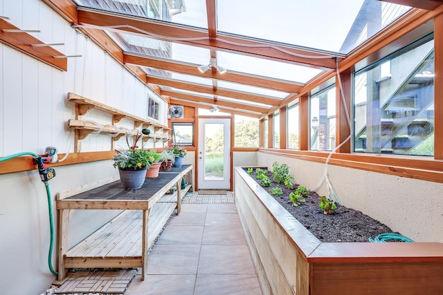sunroom / solarium with lofted ceiling and a skylight