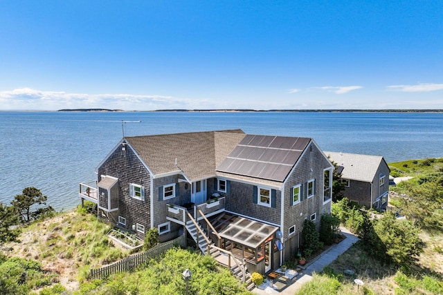 aerial view of property and surrounding area featuring a nearby body of water