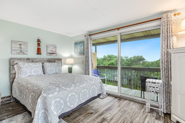 bedroom with hardwood / wood-style floors and access to outside