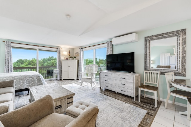 living room featuring light tile patterned floors, an AC wall unit, and lofted ceiling