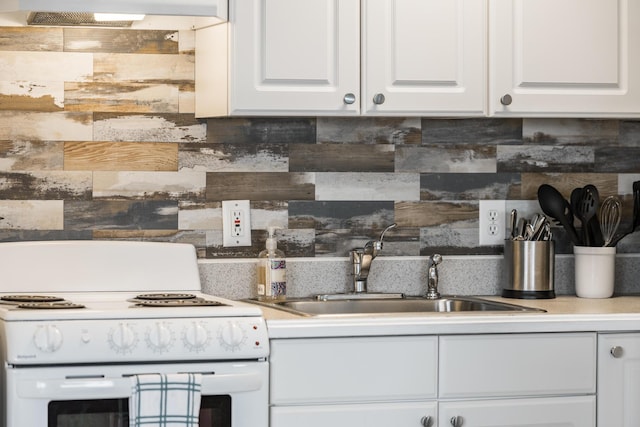 kitchen featuring white cabinets, decorative backsplash, white range with electric cooktop, and sink