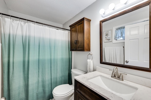 bathroom with toilet, a textured ceiling, and vanity