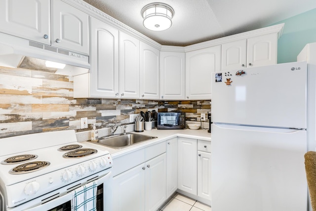 kitchen with sink, white appliances, and white cabinetry