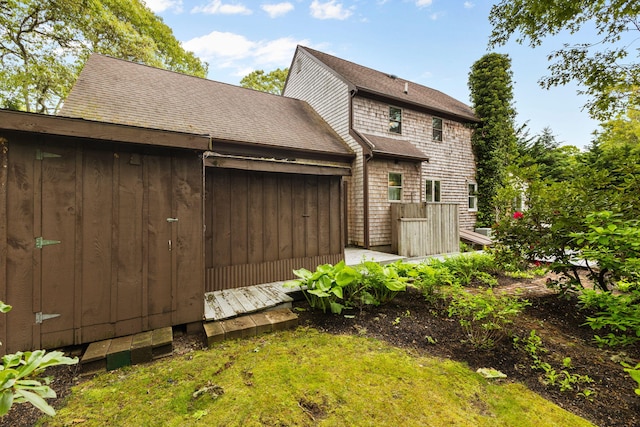 29 Windward Walk, Harwich Port, MA 02646 - rear view of house featuring an attached garage and roof with shingles
