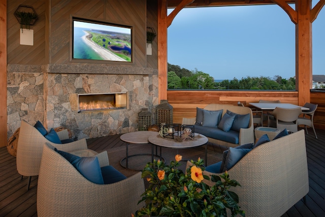 view of patio / terrace featuring a deck and an outdoor living space with a fireplace