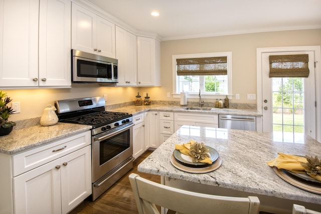 kitchen featuring sink, stainless steel appliances, white cabinets, and light stone countertops