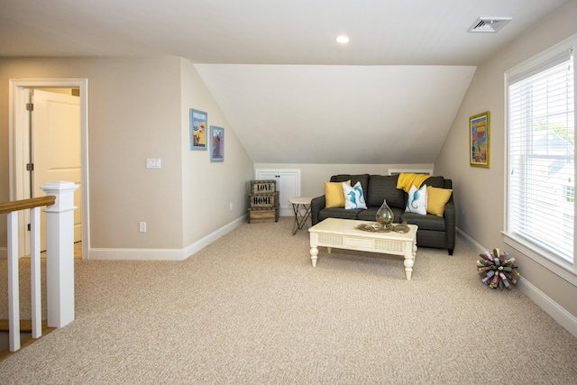 sitting room with carpet floors and lofted ceiling