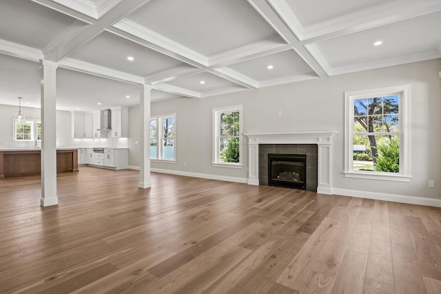 14 Azalea Ln, Mashpee, MA 02649 - unfurnished living room featuring light wood-type flooring, coffered ceiling, ornate columns, beamed ceiling, and plenty of natural light