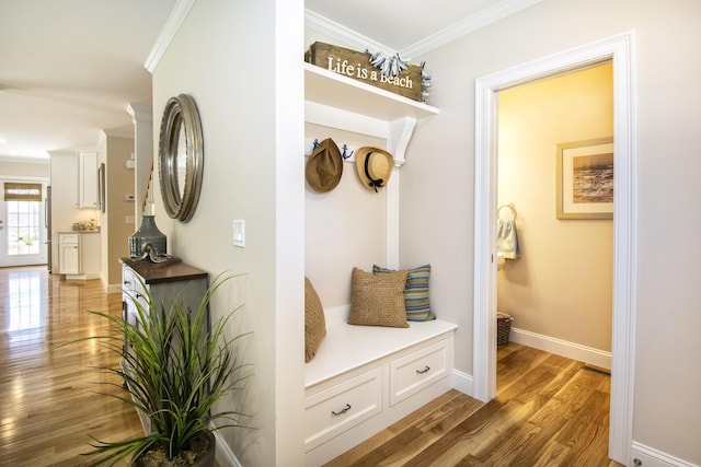 mudroom with crown molding and light hardwood / wood-style floors