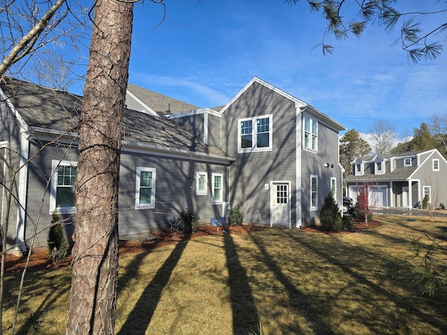 back of property featuring a lawn