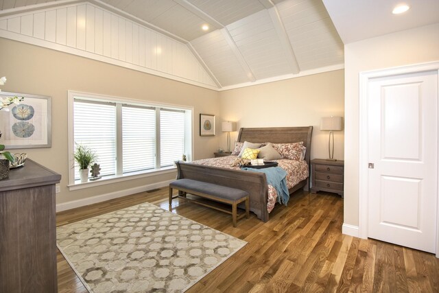 bedroom featuring dark wood-type flooring, vaulted ceiling, and wooden ceiling