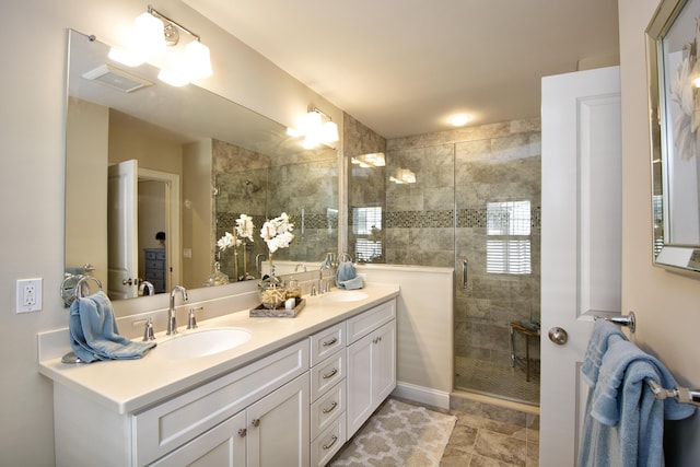 bathroom with walk in shower and vanity