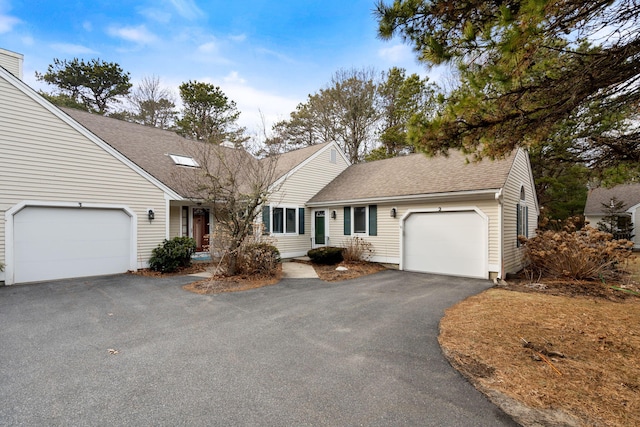 2 Pacific Ave, Mashpee, MA 02649 - view of front facade featuring a shingled roof, a garage, and asphalt driveway