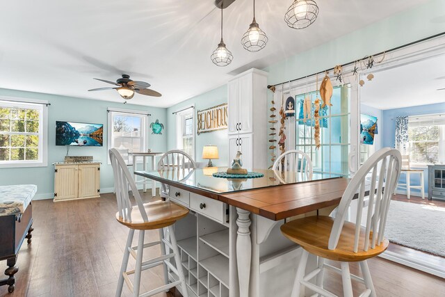 7 John St, Wareham, MA 02571 - dining space with a wealth of natural light, wood finished floors, ceiling fan, and baseboards