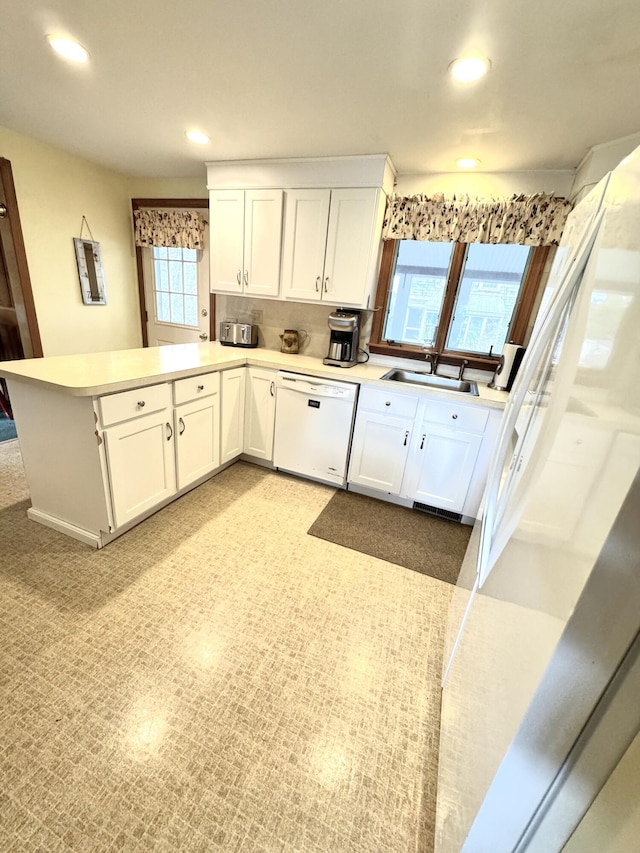 34 Charles Rd, Harwich, MA 02645 - kitchen featuring white dishwasher, a peninsula, a sink, white cabinetry, and recessed lighting