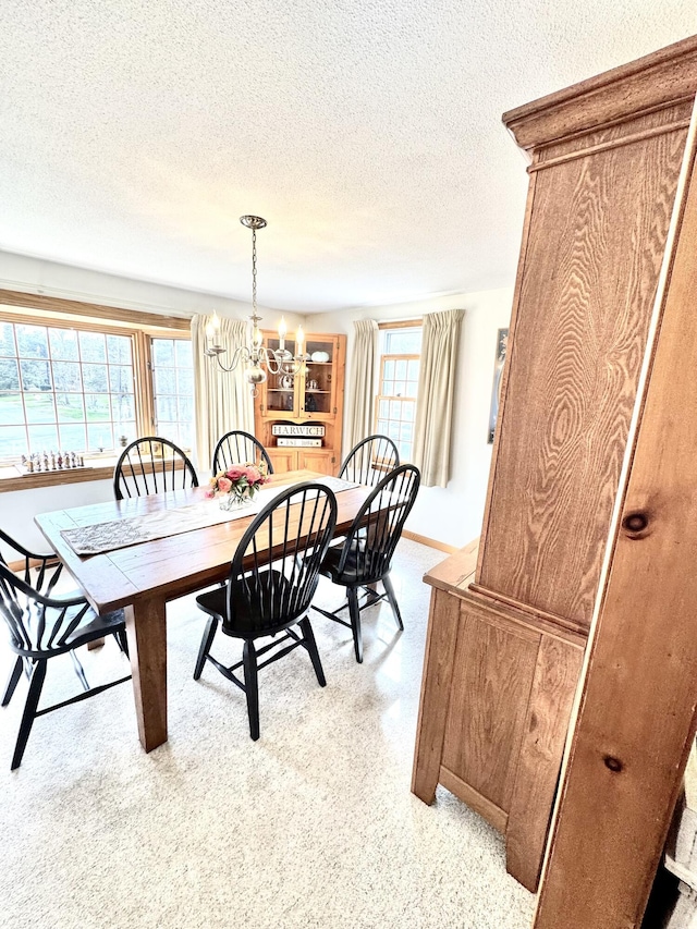 34 Charles Rd, Harwich, MA 02645 - dining area featuring a textured ceiling, a chandelier, and baseboards