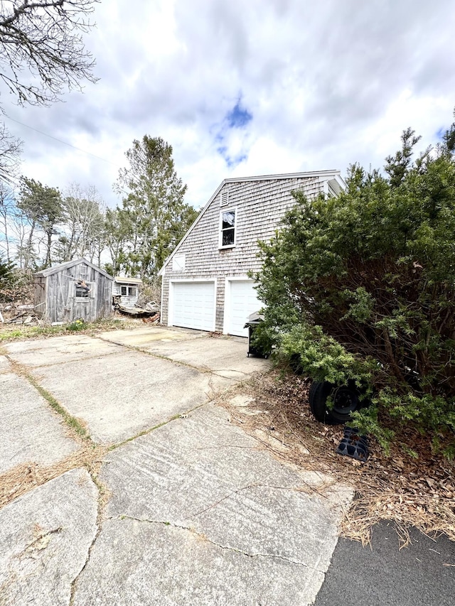 34 Charles Rd, Harwich, MA 02645 - view of property exterior featuring concrete driveway, a garage, and an outbuilding