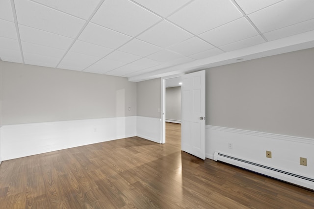 29 Sturgis Ln, Barnstable, MA 02630 - unfurnished room featuring a baseboard heating unit, a drop ceiling, and wood finished floors