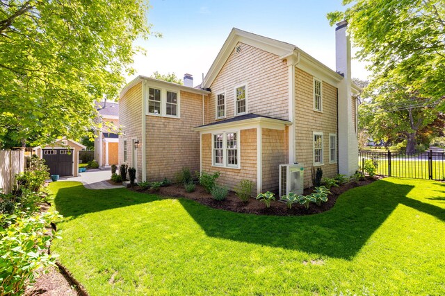 1180 Main St, Cotuit, MA 02635 - rear view of house with a chimney, ac unit, and an outdoor structure