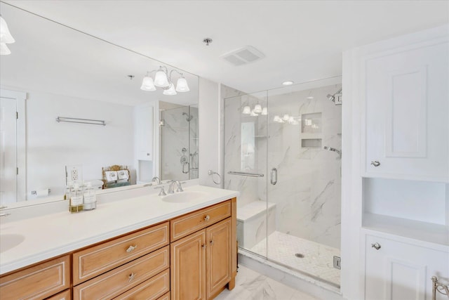 bathroom featuring a sink, visible vents, a marble finish shower, and marble finish floor