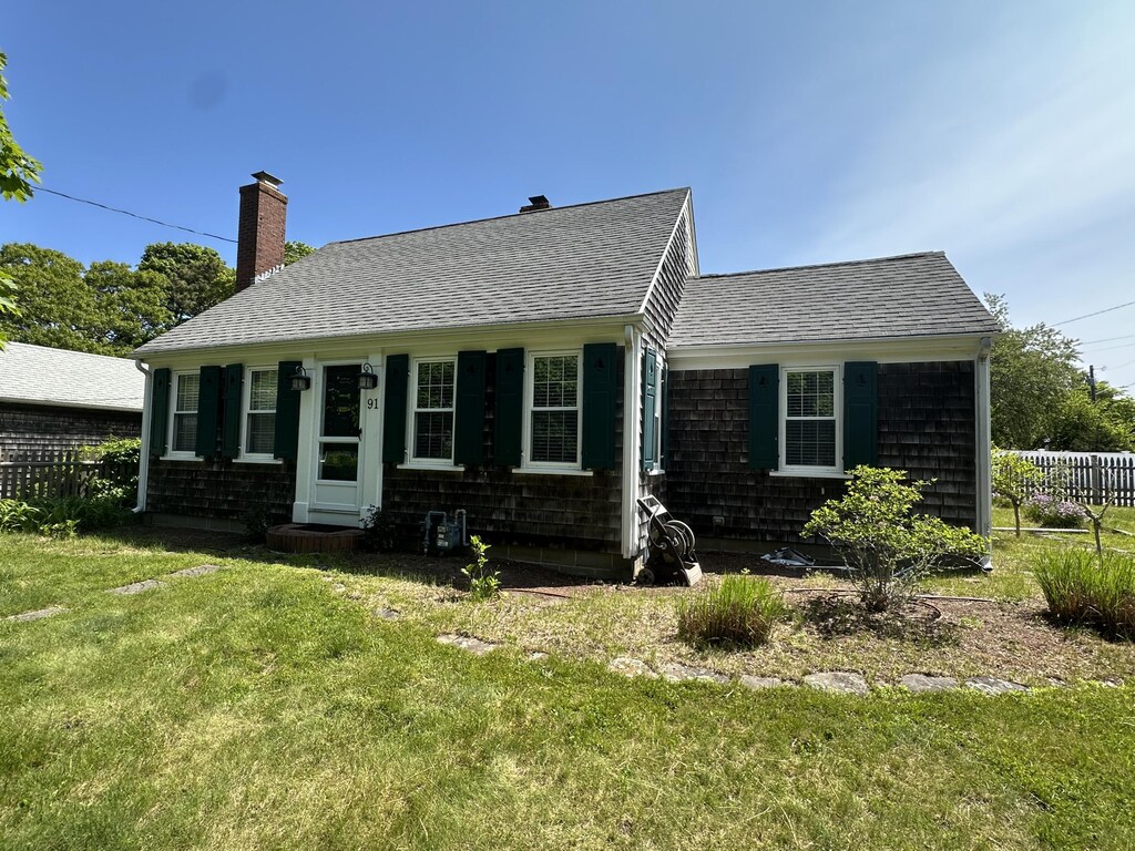 91 Division St, West Harwich, MA 02671 - view of front of property with roof with shingles and a chimney